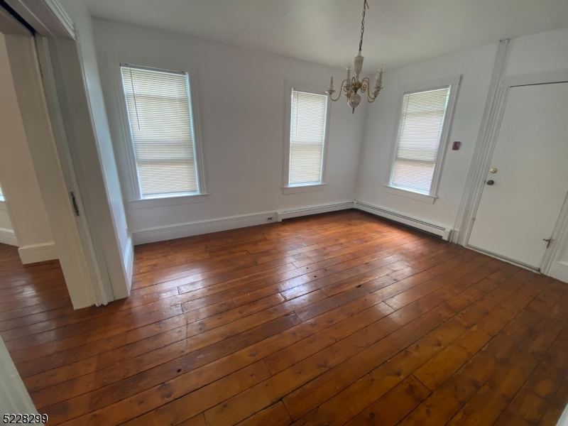 9 Dock Road Denville, NJ 07866 - Photo 7 of 21 an empty room with wooden floor and windows