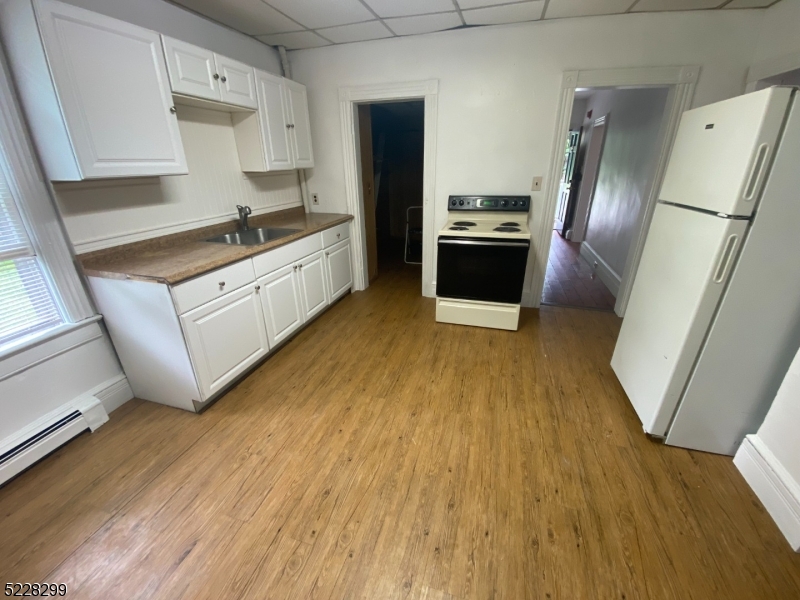 9 Dock Road Denville, NJ 07866 - Photo 8 of 21 a kitchen with granite countertop a refrigerator and a sink