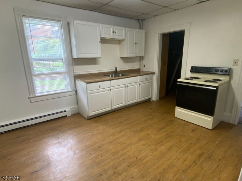 9 Dock Road Denville, NJ 07866 - Photo 9 of 21 a kitchen with granite countertop a stove a sink and a refrigerator