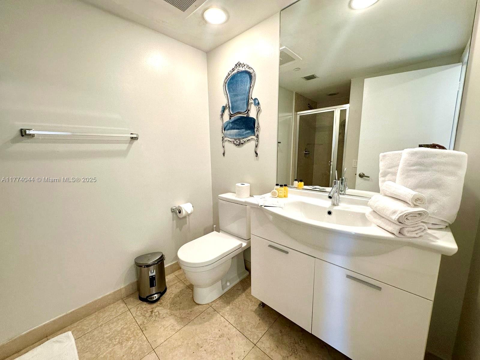 485 Brickell Avenue, Unit 4408 Miami, FL 33131 - Photo 13 of 15 a bathroom with a sink toilet and mirror