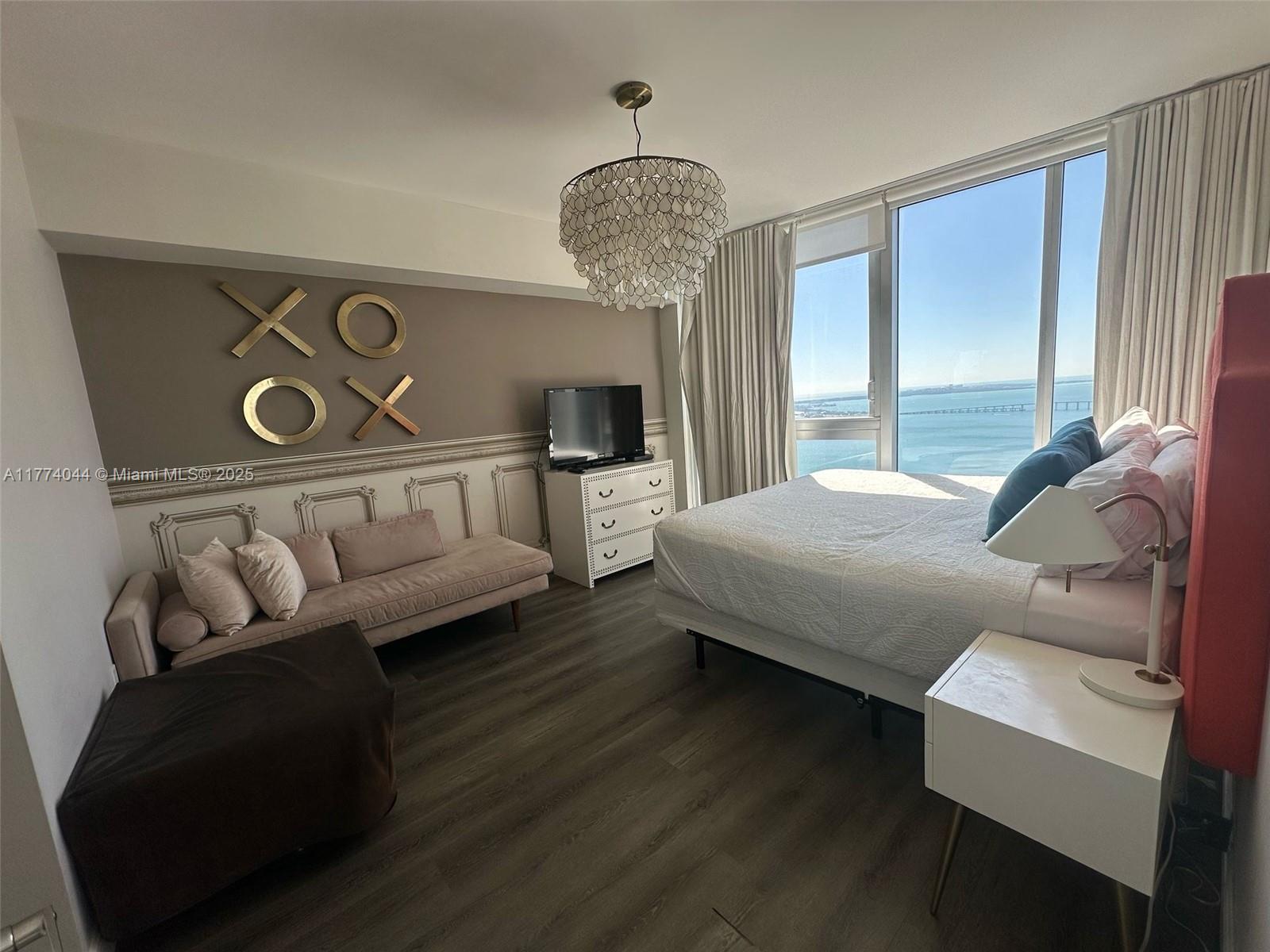 485 Brickell Avenue, Unit 4408 Miami, FL 33131 - Photo 8 of 15 a bedroom with furniture and a window