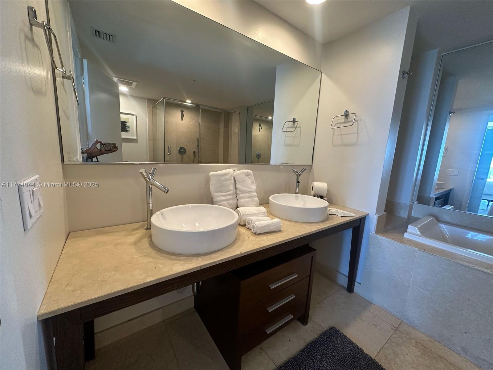 485 Brickell Avenue, Unit 4408 Miami, FL 33131 - Photo 9 of 15 a bathroom with a granite countertop sink a toilet a mirror and vanity
