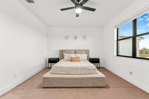 a bedroom with a bed and window