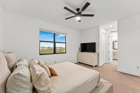 a bedroom with a bed and a television