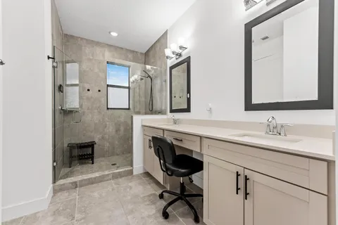 a spacious bathroom with a sink double vanity and a mirror