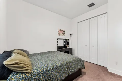 a bedroom with a bed and a chair