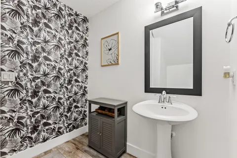 a bathroom with a sink toilet and mirror