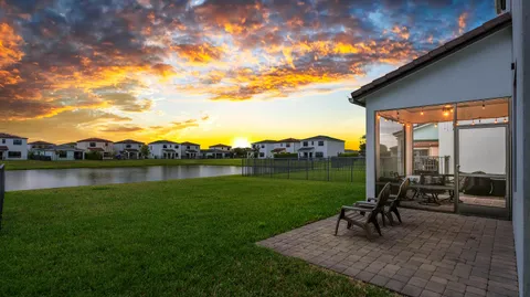 a view of a patio with chairs next to a yard