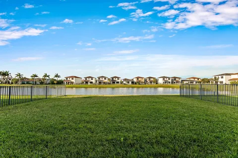 a view of a lake with houses in the back
