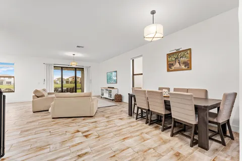 a dining room with wooden floor and breakfast area