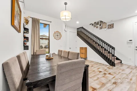 a view of a dining room with furniture and wooden floor