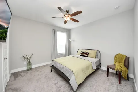 a bedroom with a bed and a window