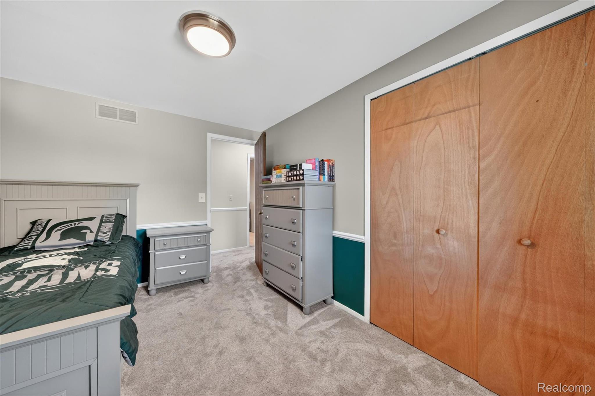 5469 Pheasant Run Road Clarkston, MI 48346 - Photo 20 of 36 Plush carpet flooring complements light grey walls with a dark teal wainscoting accent