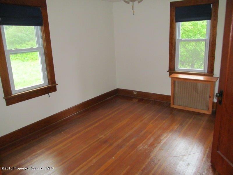 2140 Madisonville Road Moscow, PA 18444 - Photo 12 of 23 an empty room with wooden floor and windows