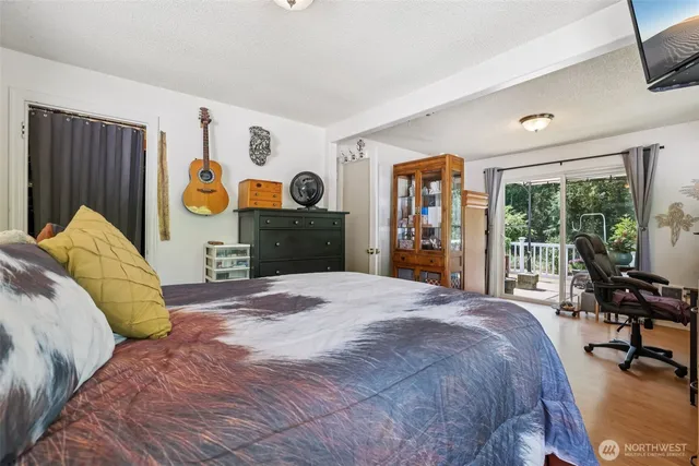 a bedroom with a bed and a large mirror