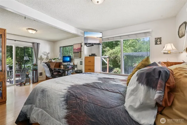 a bed sitting in a bedroom next to a window