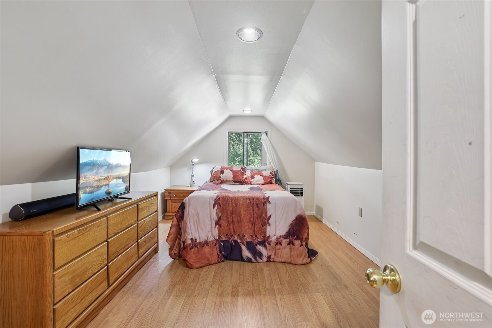17209 West Riverside Drive Bothell, WA 98011 - Photo 17 of 39 a bedroom with a bed and wooden floor