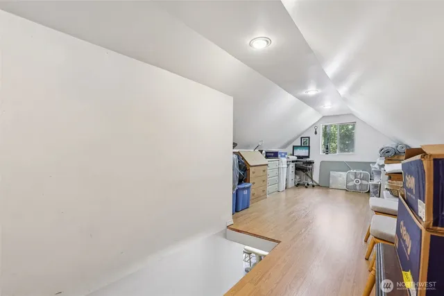 a view of a room with wooden floor