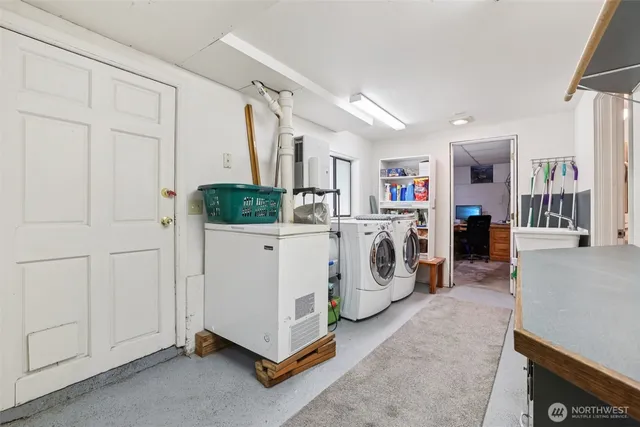 a utility room with cabinets dryer and washer