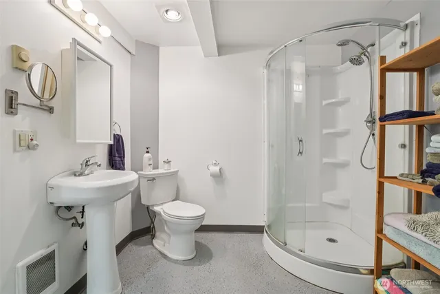 a bathroom with a sink toilet and shower