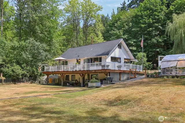 a view of a house with swimming pool and sitting area