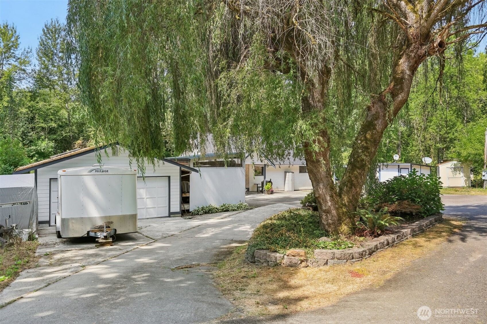 17209 West Riverside Drive Bothell, WA 98011 - Photo 3 of 39 a view of a house with backyard and trees
