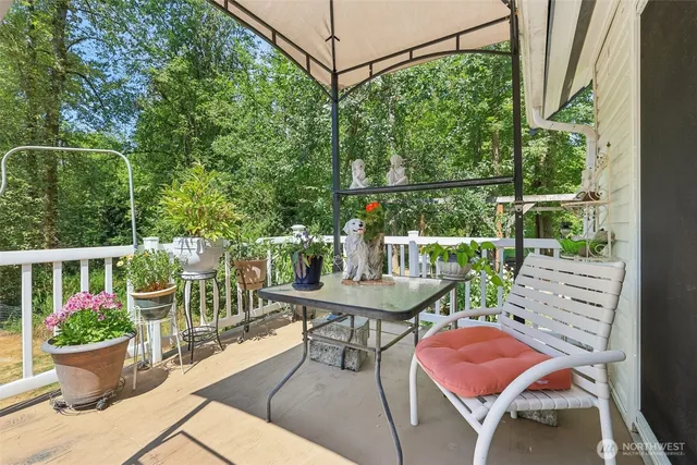 a view of a chair and table in the balcony