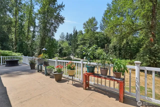 a view of deck with furniture and trees