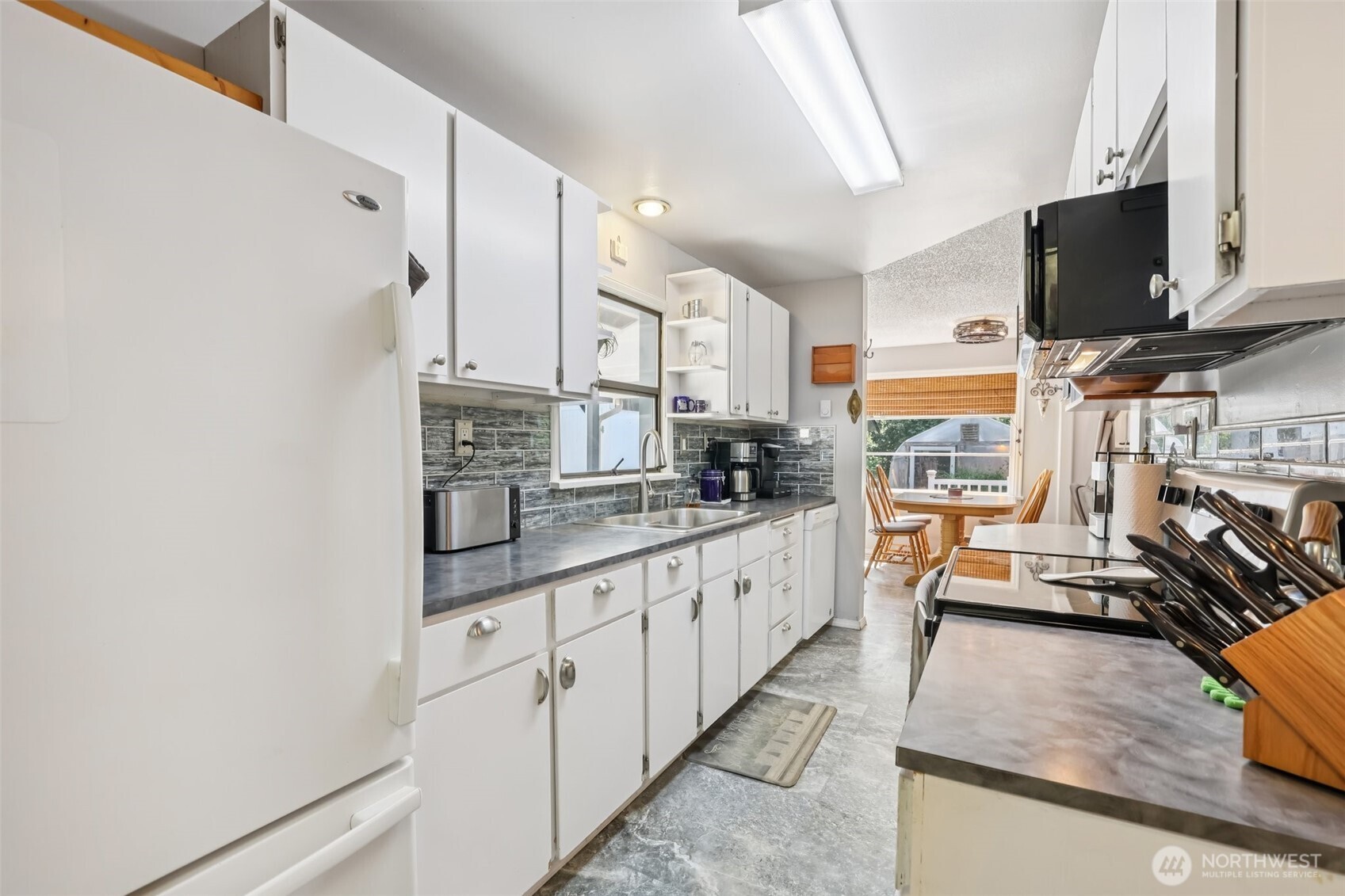 17209 West Riverside Drive Bothell, WA 98011 - Photo 10 of 39 a kitchen with stainless steel appliances granite countertop a sink stove and cabinets