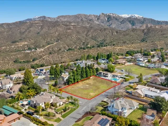 an aerial view of residential house with an outdoor space and mountain view