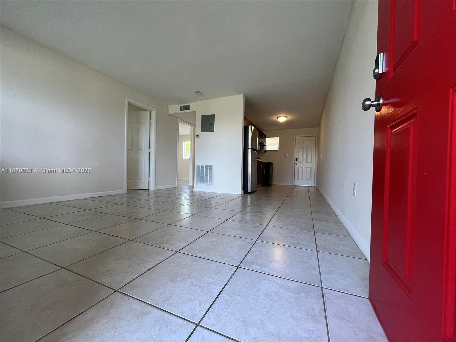 1610 North 25th Street, Unit 8 Fort Pierce, FL 34947 - Photo 2 of 7 a view of an empty room with a window