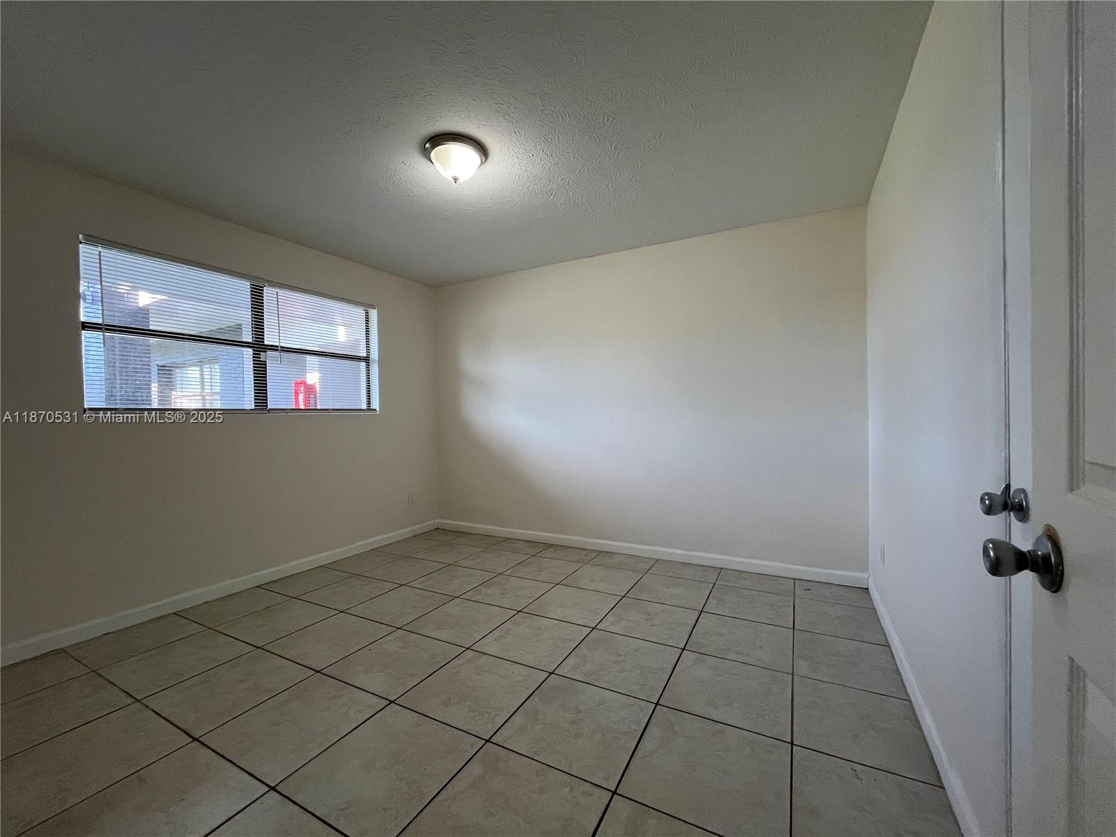 1610 North 25th Street, Unit 8 Fort Pierce, FL 34947 - Photo 5 of 7 an empty room with windows