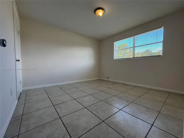 an empty room with a empty space and window