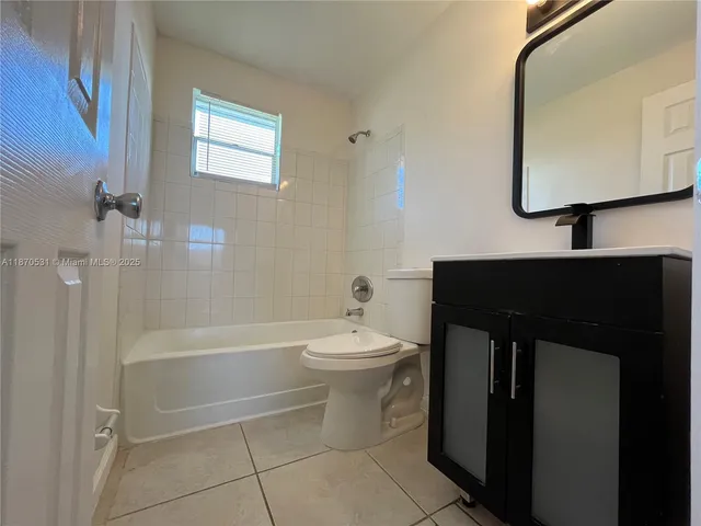 a bathroom with a sink a toilet and bathtub