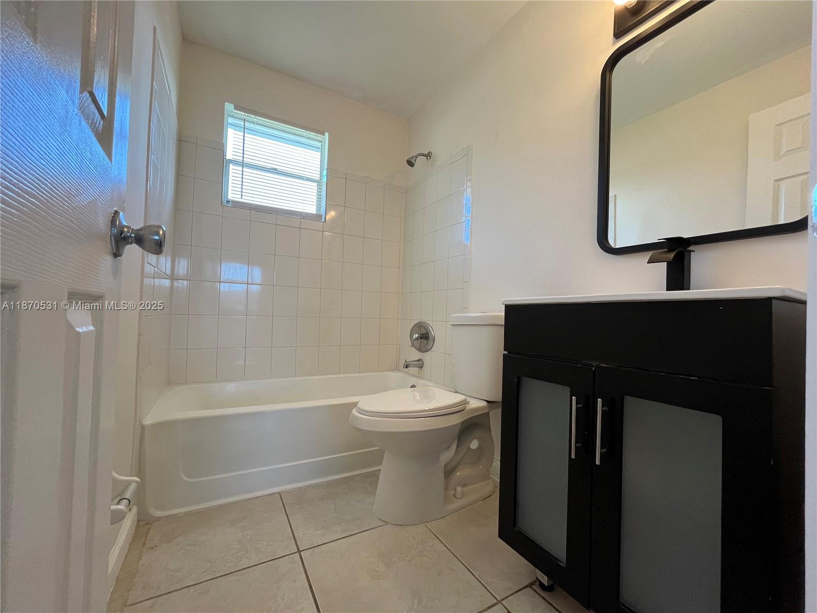 1610 North 25th Street, Unit 8 Fort Pierce, FL 34947 - Photo 7 of 7 a bathroom with a sink a toilet and bathtub
