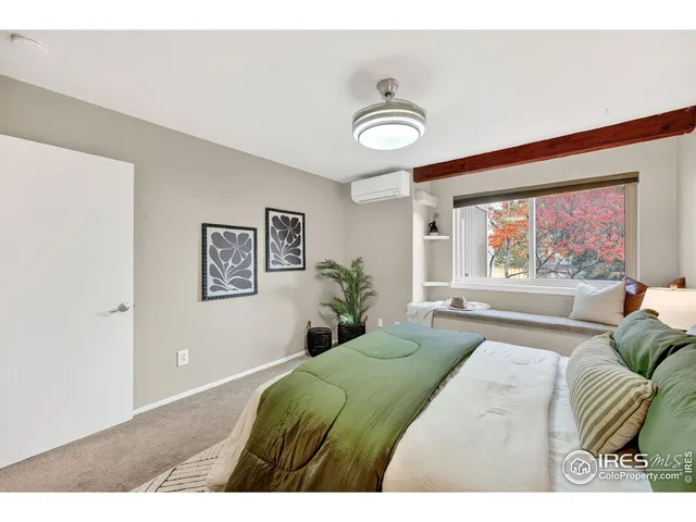 a bedroom with a large bed and a large window