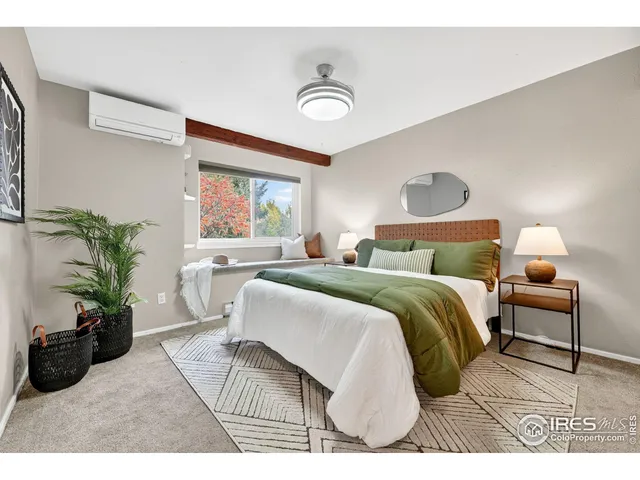 a bedroom with a bed and a potted plant