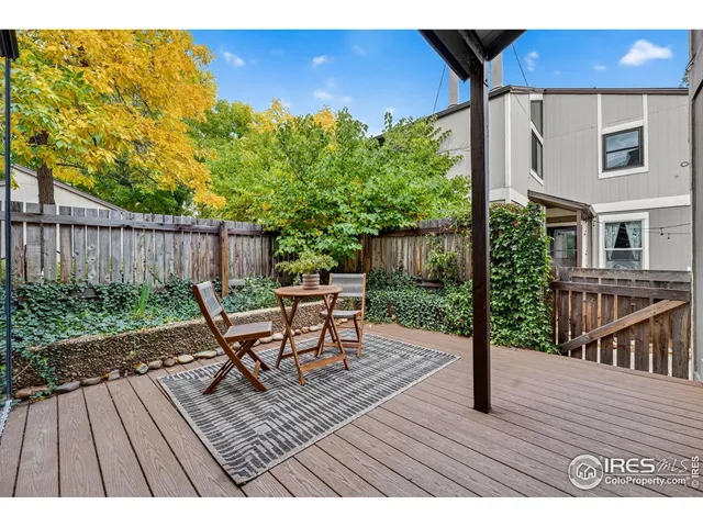 a view of backyard with deck and wooden floor