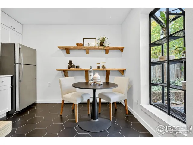 a dining room with furniture and window