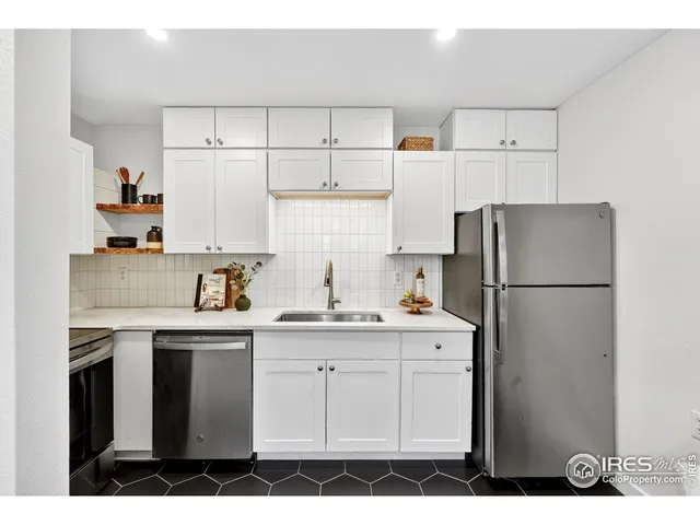 a kitchen with appliances a sink and lots of cabinets