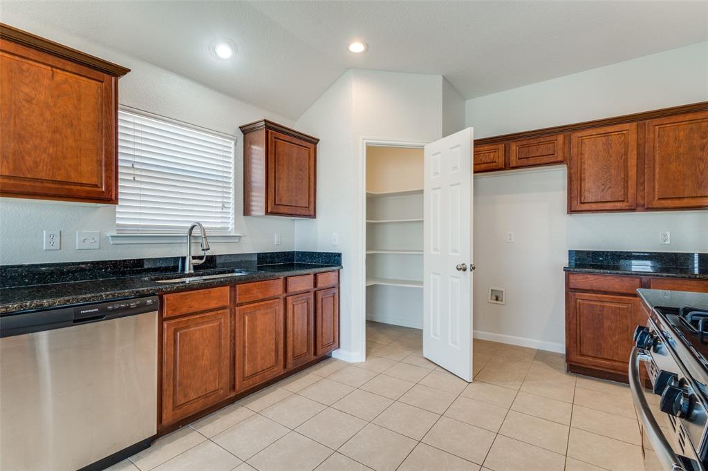 1257 Barrel Run Fort Worth, TX 76052 - Photo 12 of 29 a kitchen with granite countertop a sink and a stove