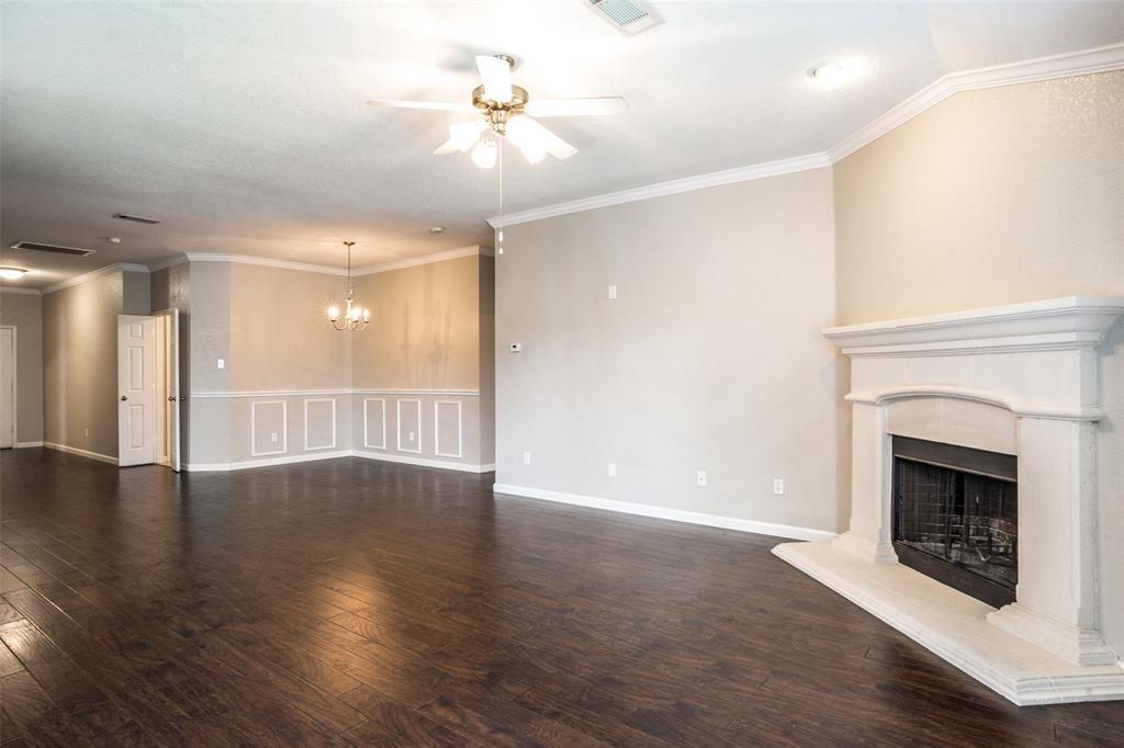 1257 Barrel Run Fort Worth, TX 76052 - Photo 9 of 29 a view of an empty room with wooden floor fireplace and a window