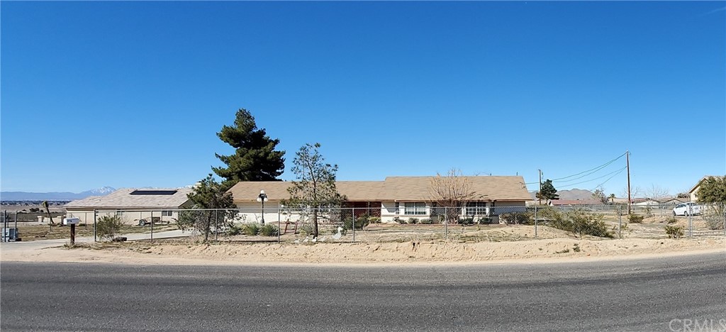 16636 Joshua Road Apple Valley, CA 92307 - Photo 1 of 1 a view of a building with a yard
