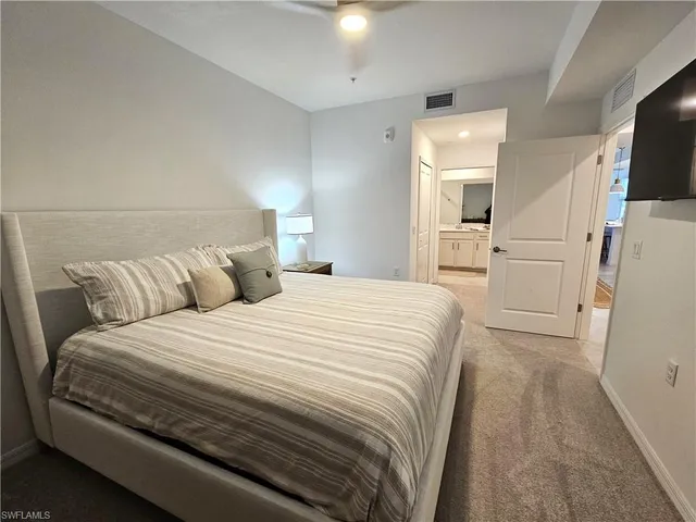 a large white bed in a white room