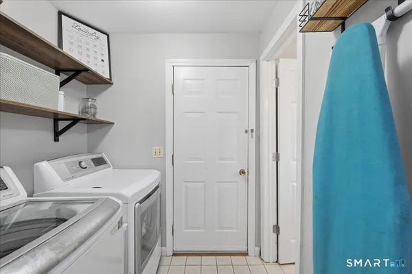 a bathroom with a toilet a sink a vanity and mirror