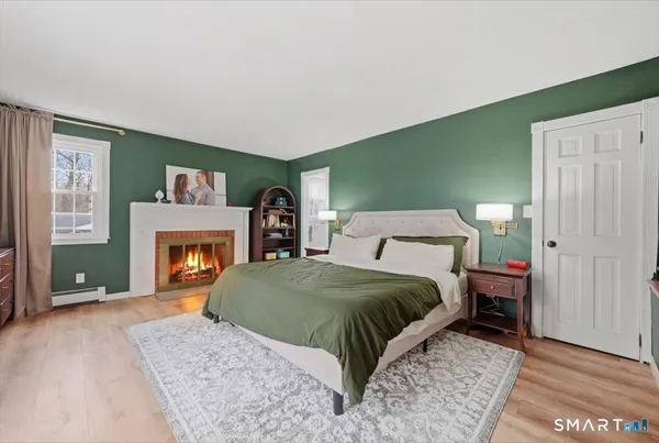 a bedroom with furniture and a window