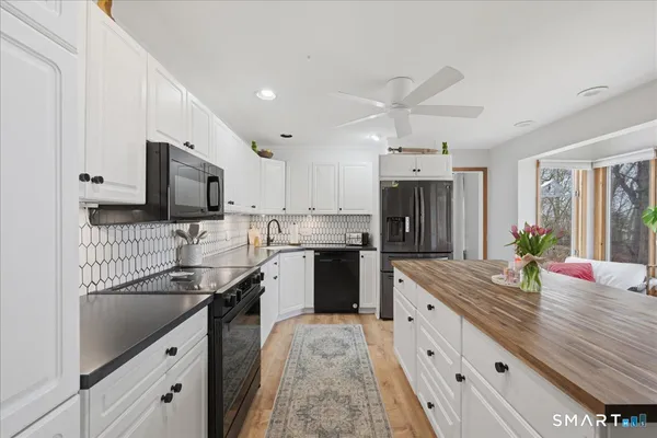 a view of kitchen with furniture and fireplace