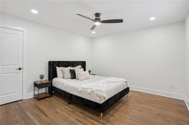 a bedroom with a bed and a ceiling fan