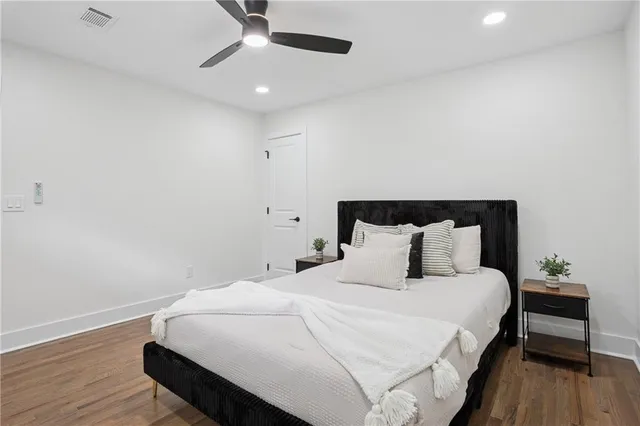 a large bed sitting in a bedroom next to a wooden floor