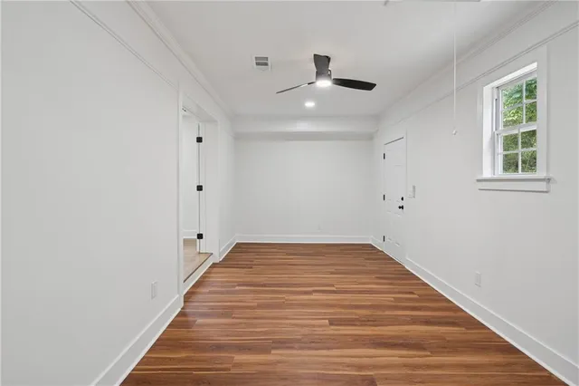wooden floor in an empty room with a window